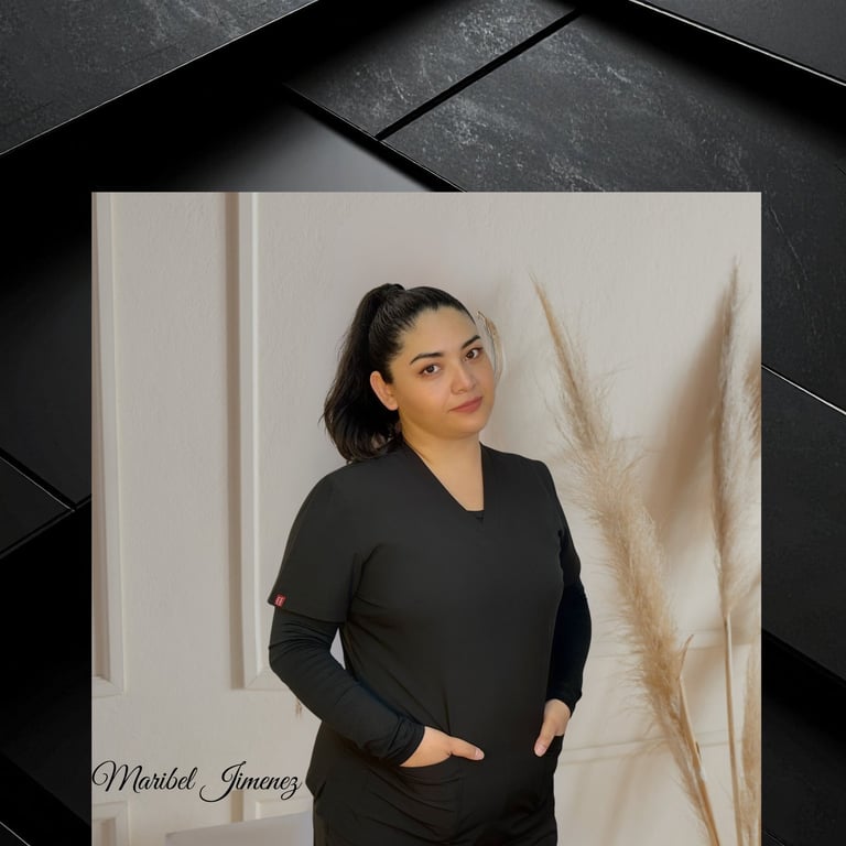 Woman in black long-sleeve top posing against white wall with pampas grass decoration and geometric black background